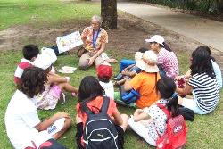 Young learner class ilearnikng English in the park